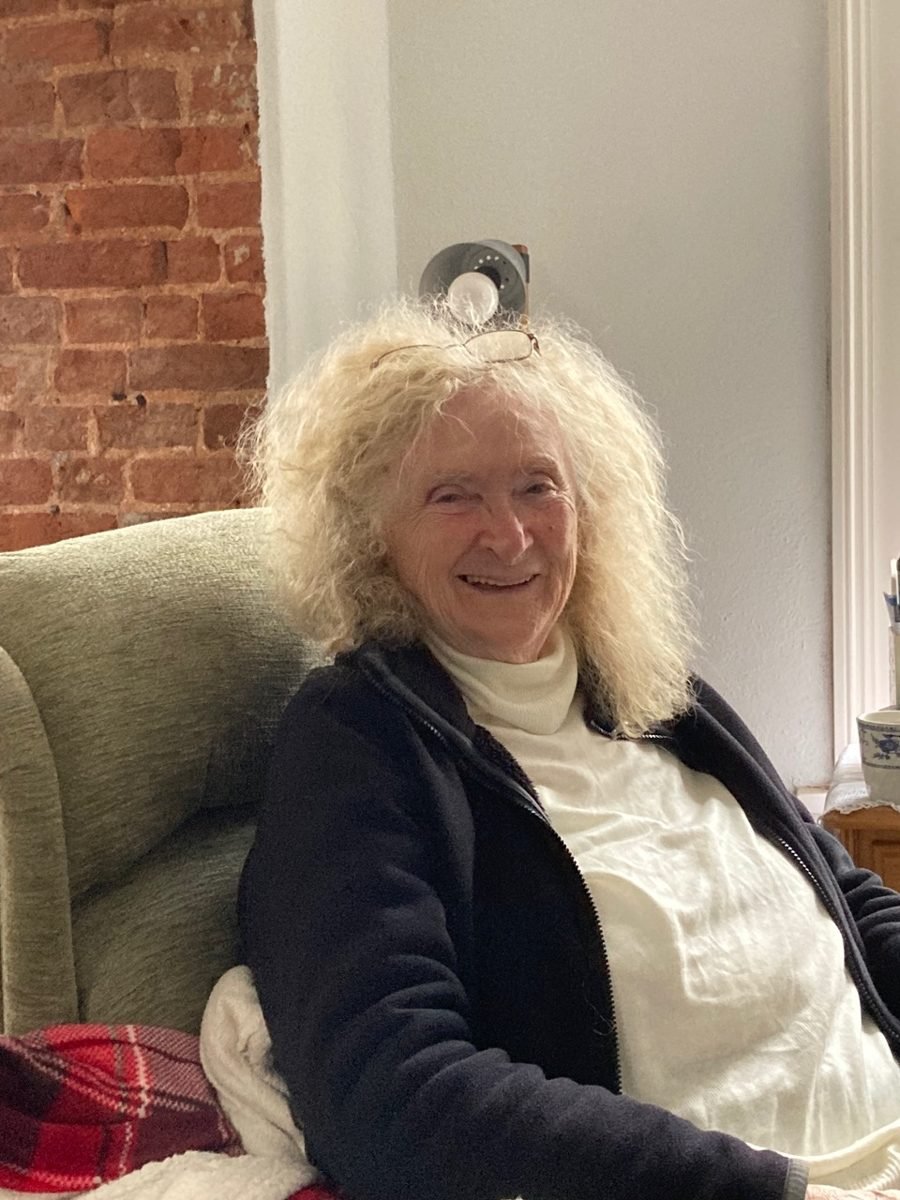 Portrait of Marlene Gardner in later life, smiling in an armchair